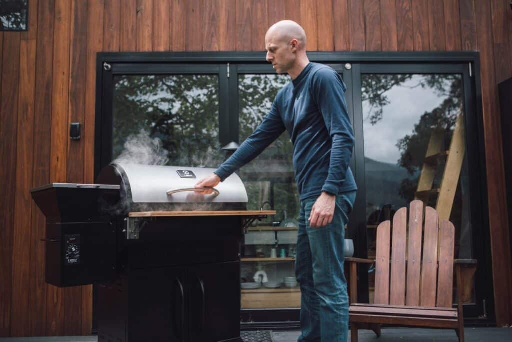 Smoking meat covered grill