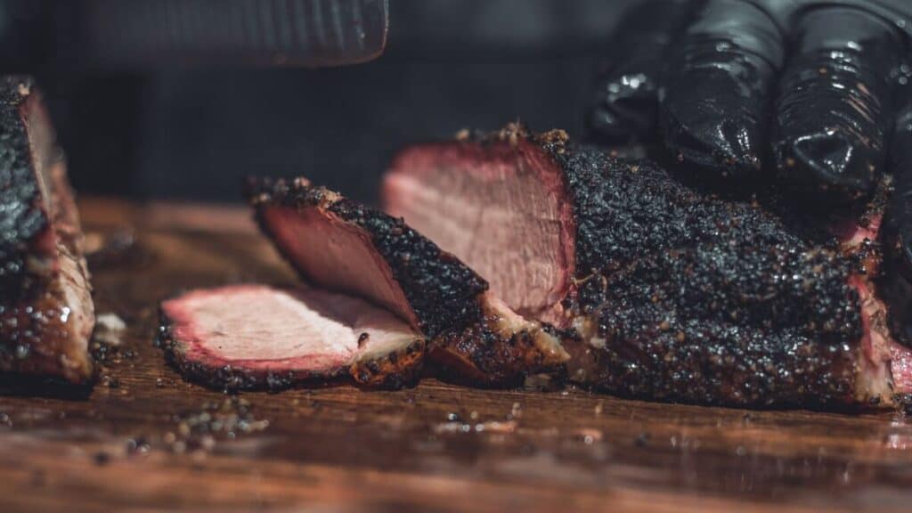 slicing juicy smoked brisket